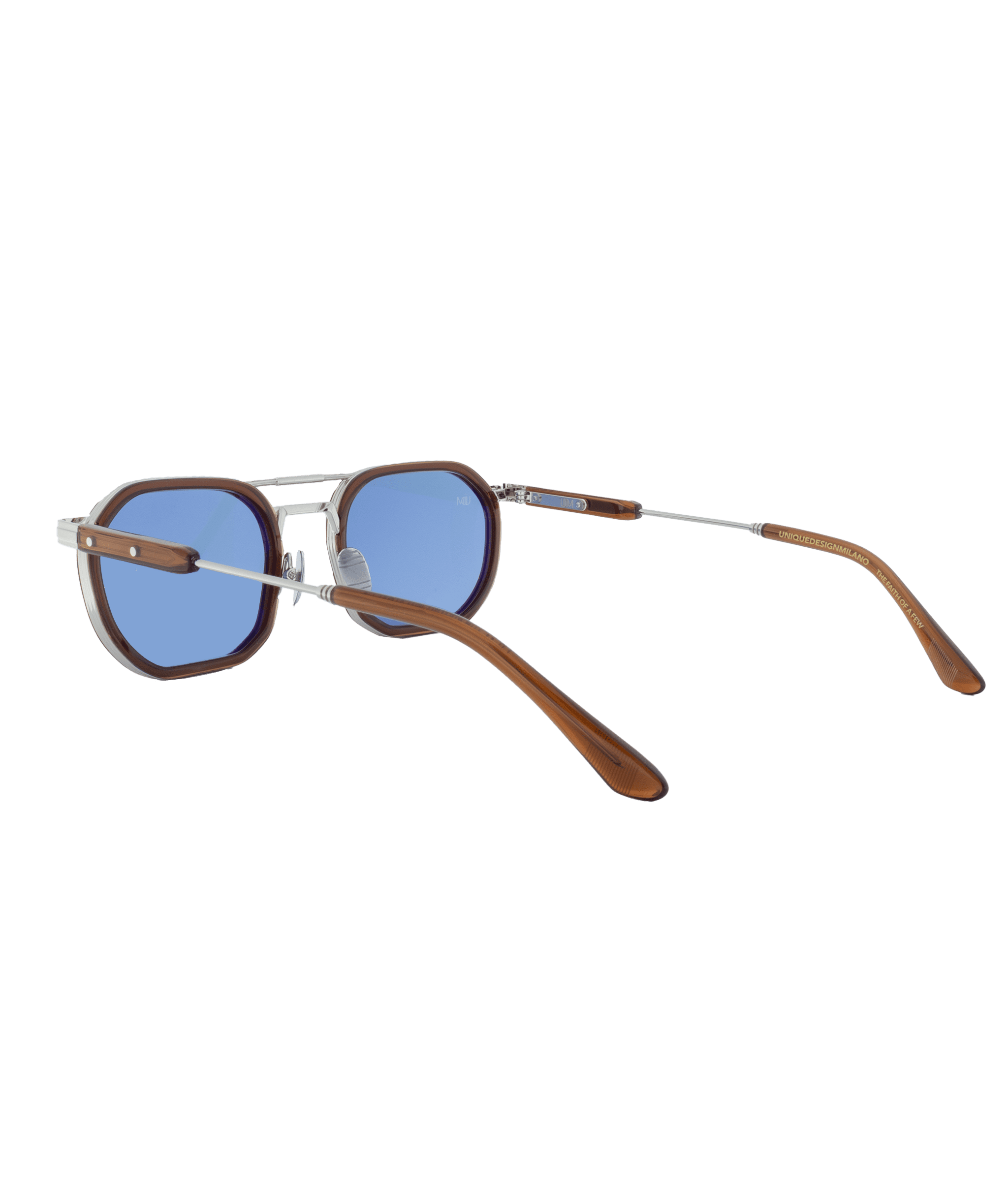 A pair of sunglasses with blue lenses, brown rounded frames, silver metal bridge and temples, and brown earpieces, displayed against a white background from Vu—la lunetterie à Montréal avec le plus grand inventaire de montures à Montréal.