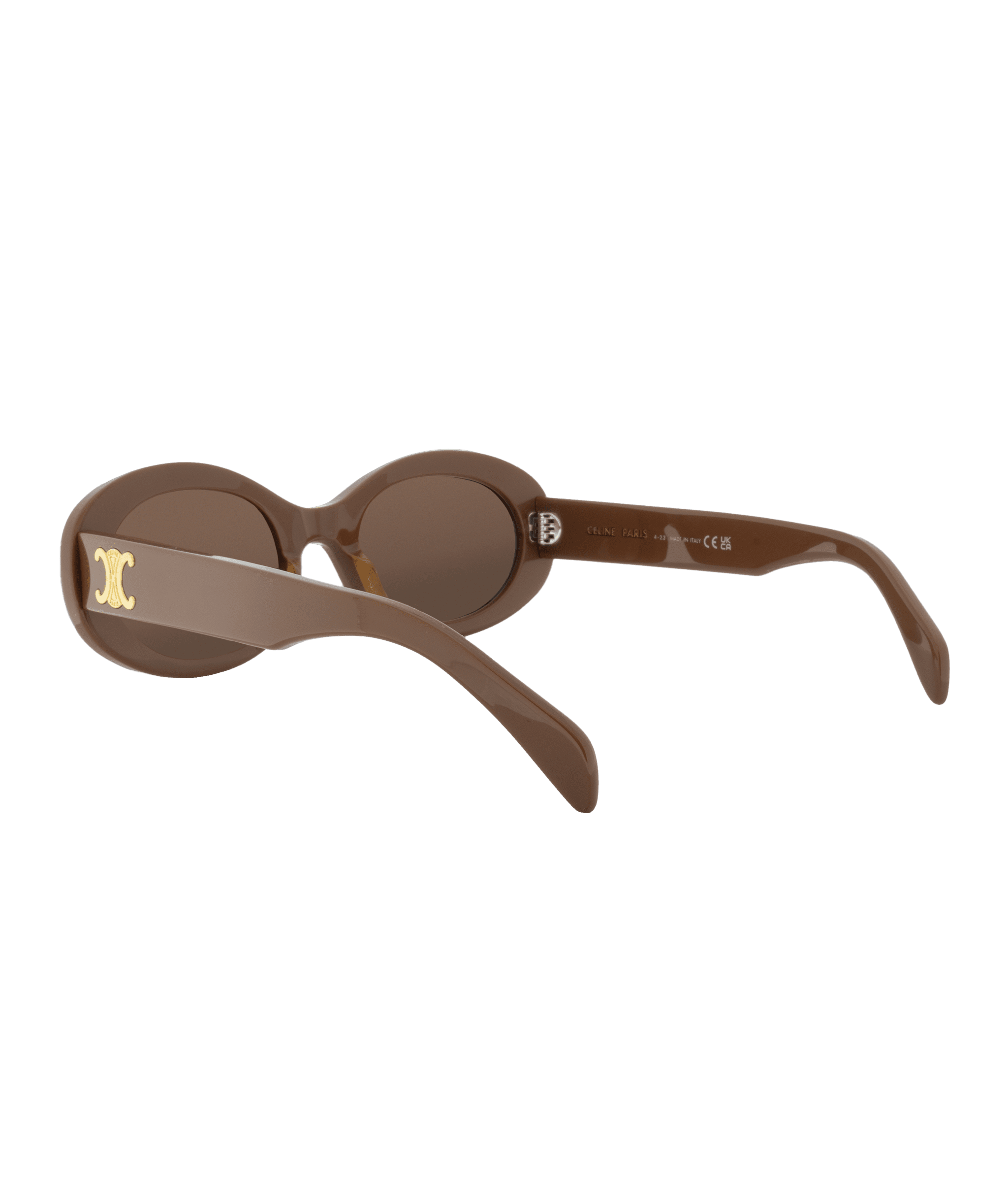 A pair of brown oval sunglasses with thick frames, featuring a gold decorative emblem on the temple. Discover this style and more at Vu, la lunetterie à Montréal avec le plus grand inventaire de montures à Montréal.